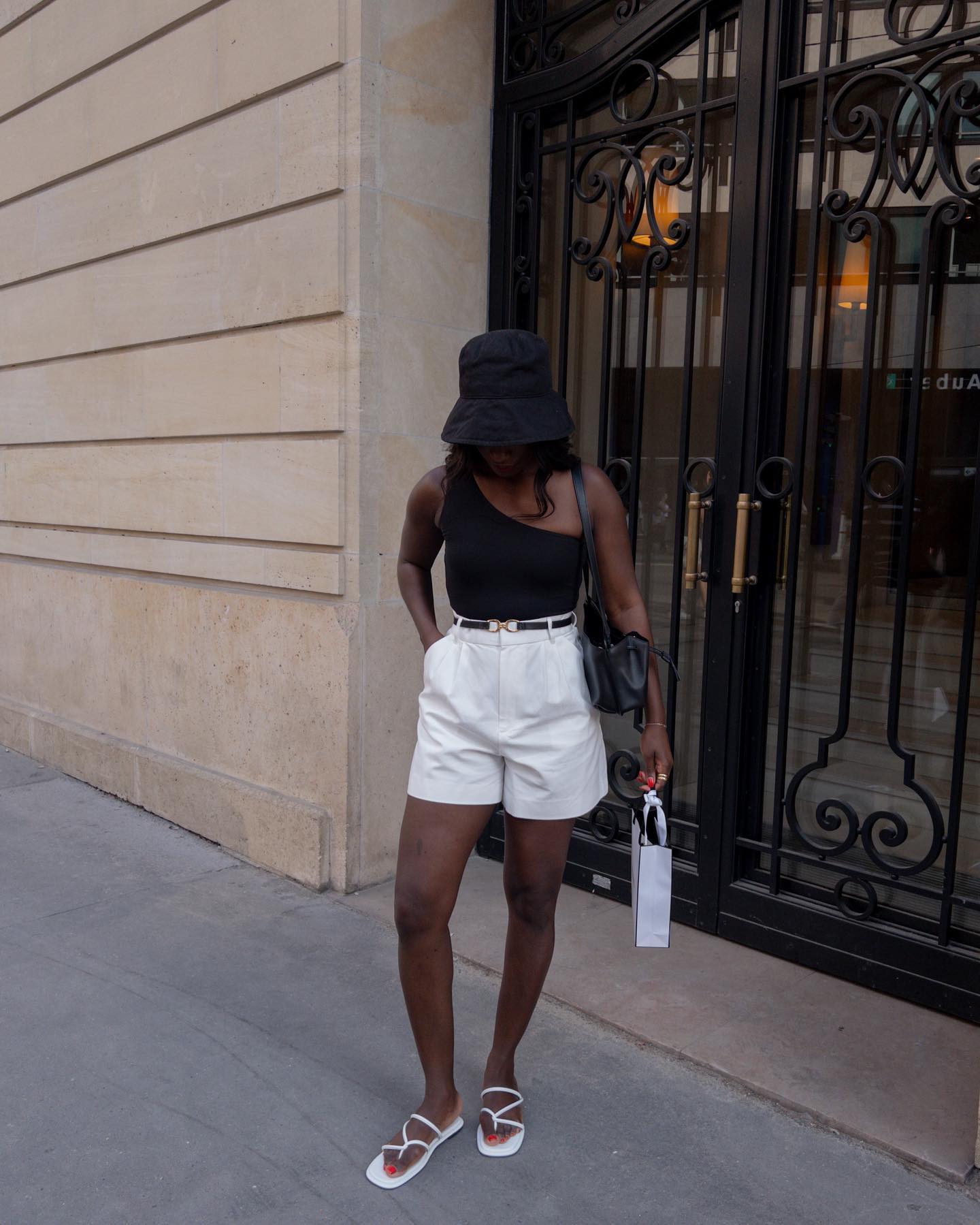 Instagram photo of AIDA BADJI in black top and white shorts