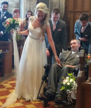 Emily Gardiner with dad on her wedding day in church