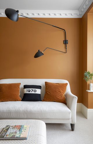 Orange living room with white ceiling and white sofa