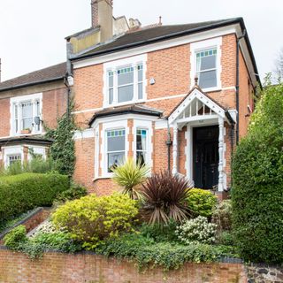 exterior with plants and shrubs with brick wall