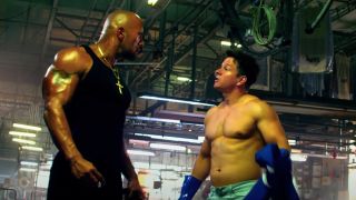 Dwayne Johnson and Mark Wahlberg having a muscle fueled argument in Pain & Gain.