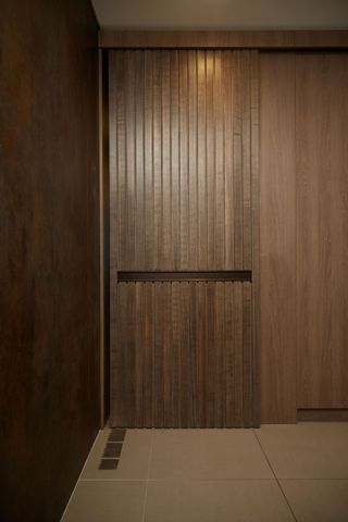 Sliding door that flows seamlessly with the wooden walls around it