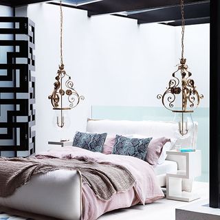 pink and white bedroom with dramatic pendant lights