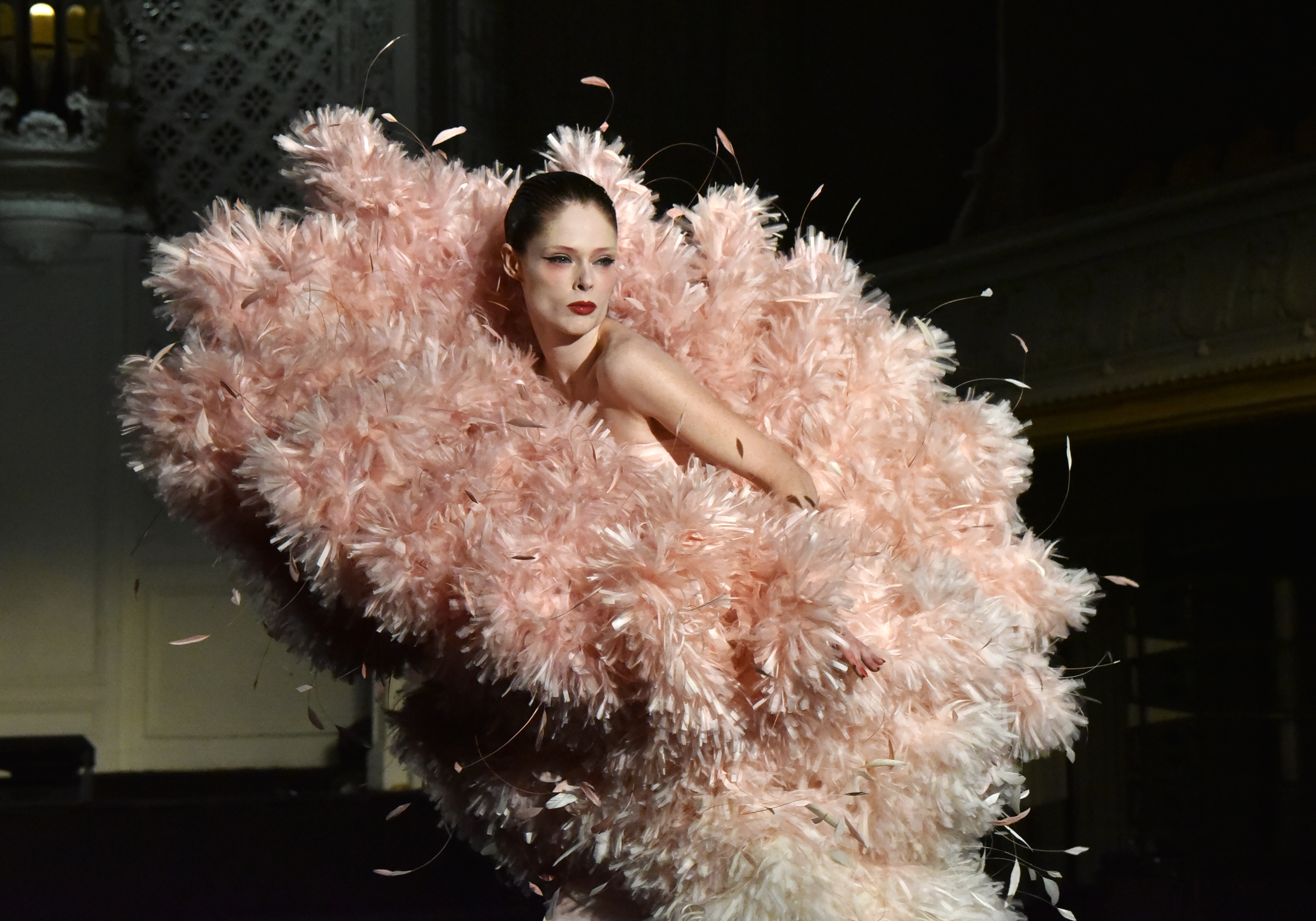 Coco Rocha on the runway in a large, feather-like haute couture dress