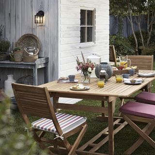 garden area with wooden dining table and chairs