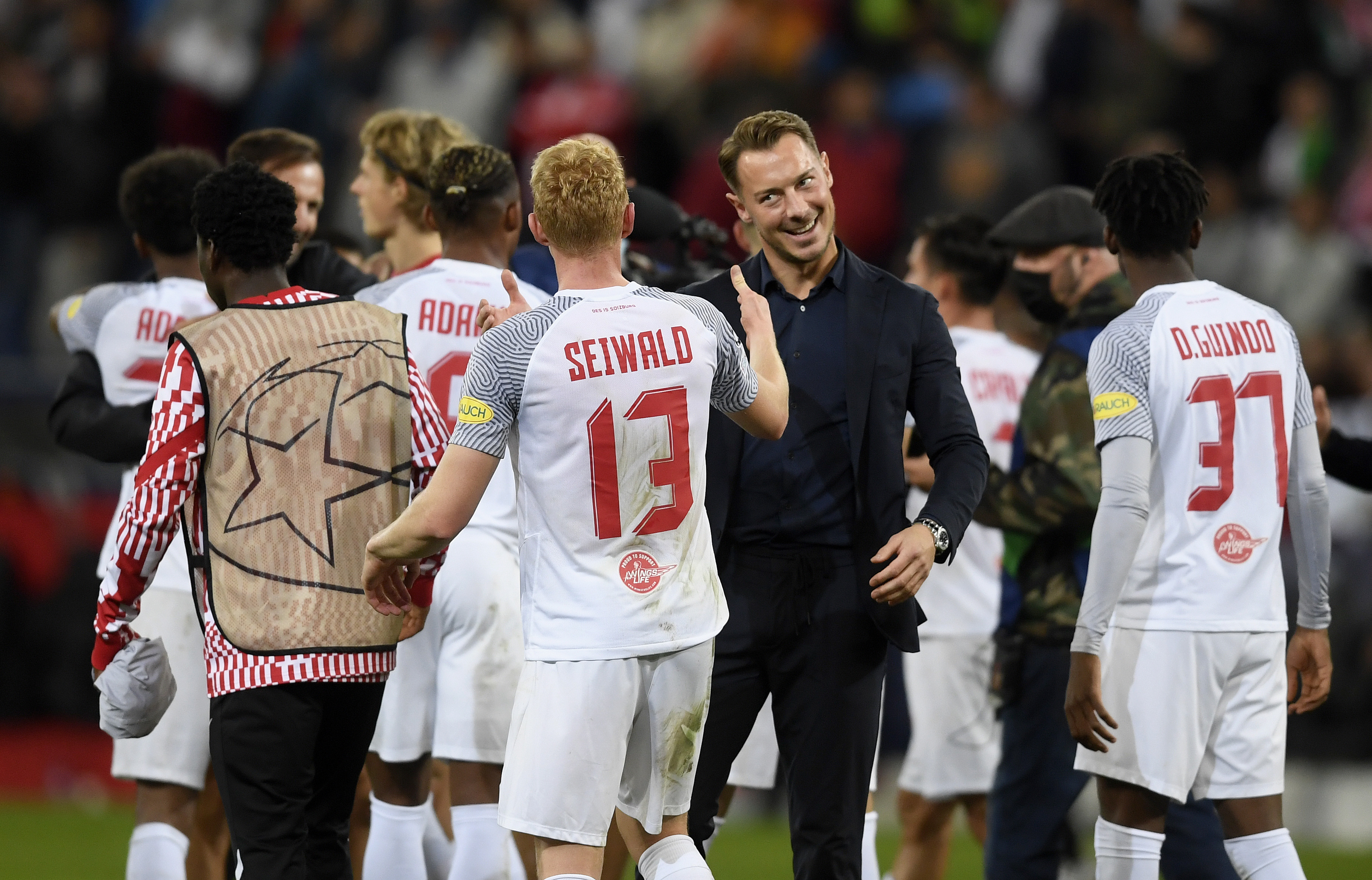 SALZBURG, AUSTRIA - OCTOBER 20: Team cach Matthias Jaissle (4thR) of FC Salzburg celebrates his team&amp;amp;apos;s victory with Nicolas Seiwald after the UEFA Champions League group G match between FC Salzburg and VfL Wolfsburg at Red Bull Arena on October 20, 2021 in Salzburg, Austria. (Photo by Andreas Schaad - FC Red Bull Salzburg/Getty Images)