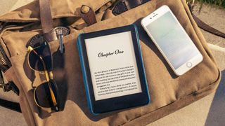 Amazon Kindle device placed on top of a brown satchel