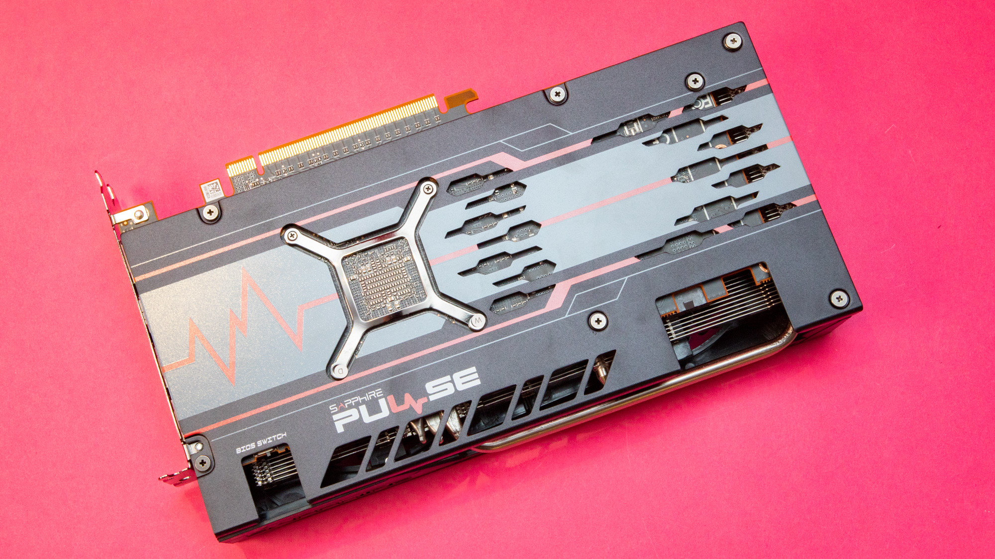 A Sapphire Pulse Radeon RX graphics card against a red background