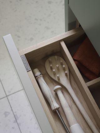 a kitchen drawer with separators for utensils