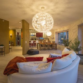 living area with white sofa and cushions and wooden floor