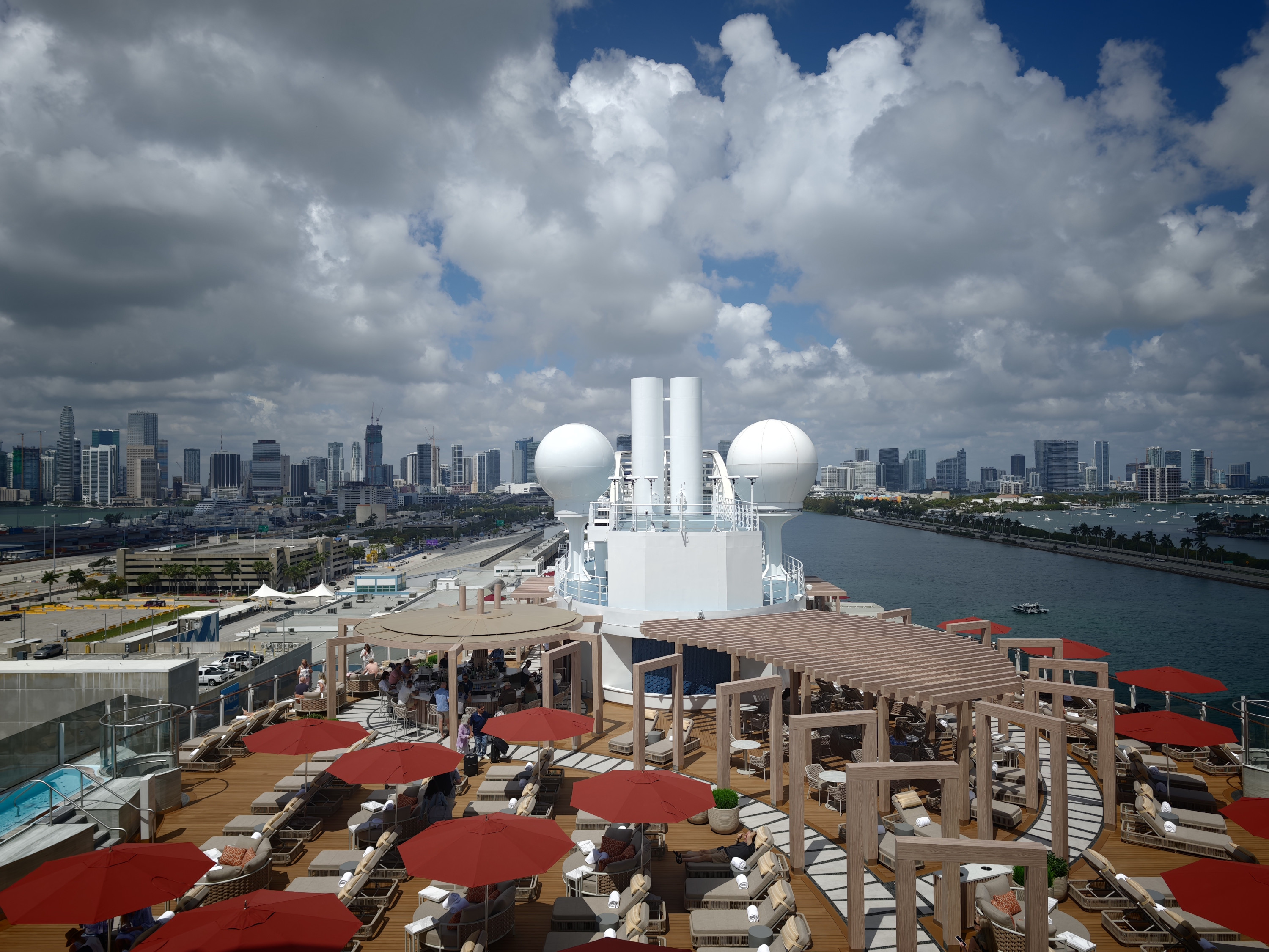 The Miami skyline behind the Vibe Club deck of Norwegian Luna