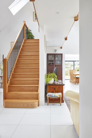 pale living spaces with wooden staircase