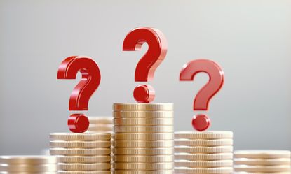 Red question marks on coin stacks before a defocused background.