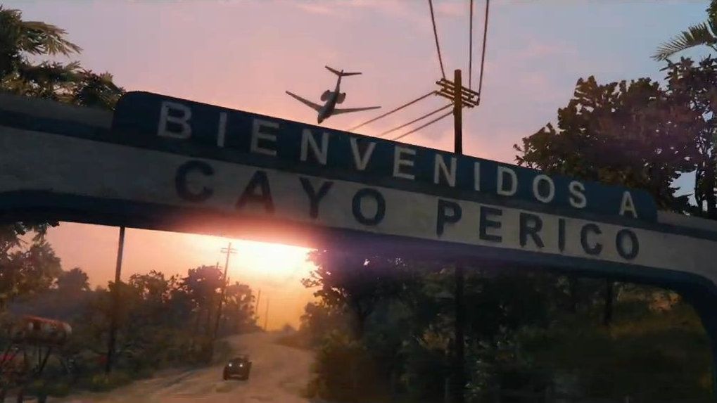 A plane flies over a sign reading &quot;Cayo Perico&quot; against the sunset.