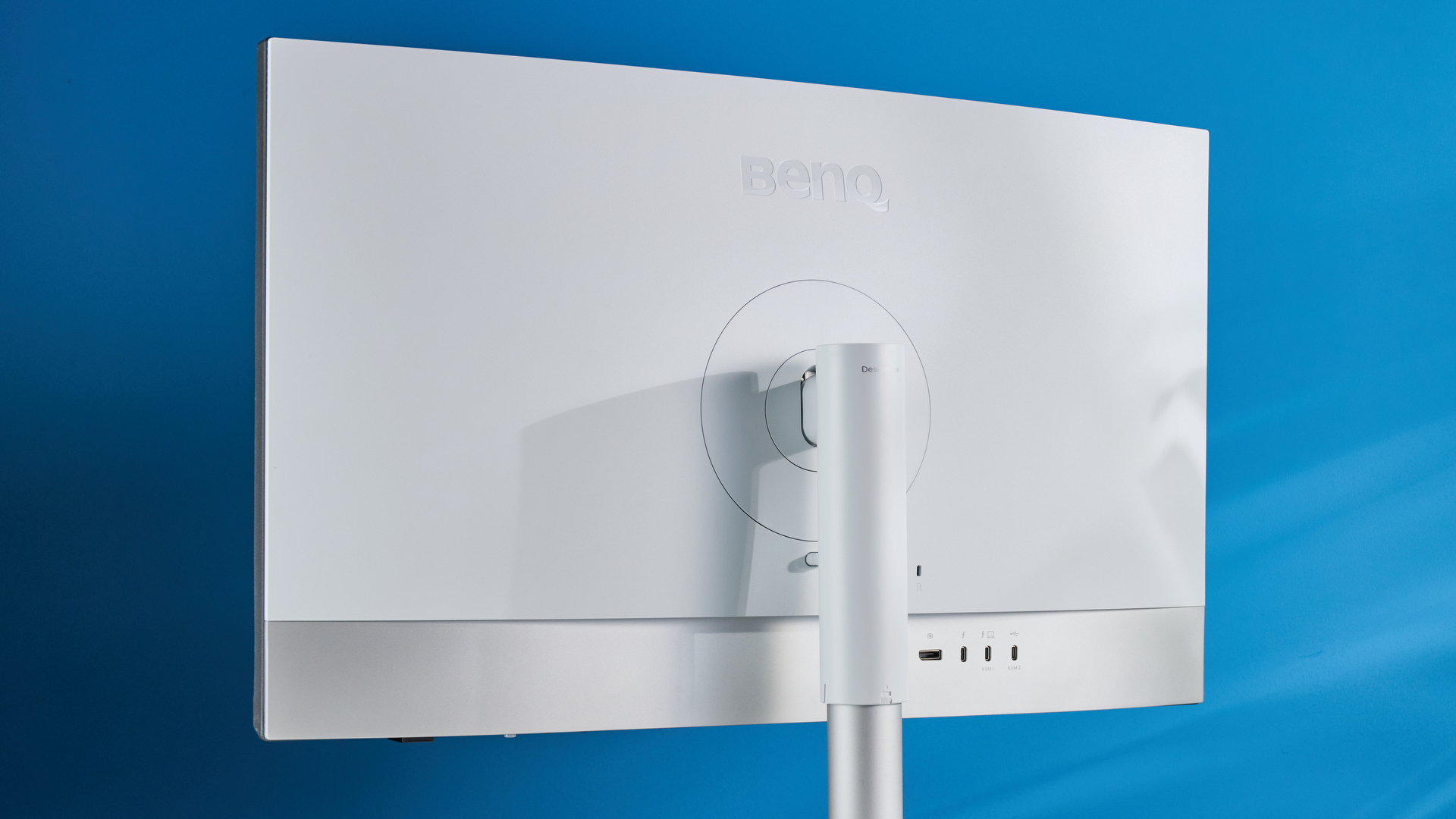 A photo of the BenQ PD3226G monitor in a blue-walled studio