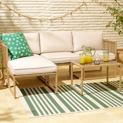 Tesco Florence modular outdoor sofa set on patio with cushions and decorations