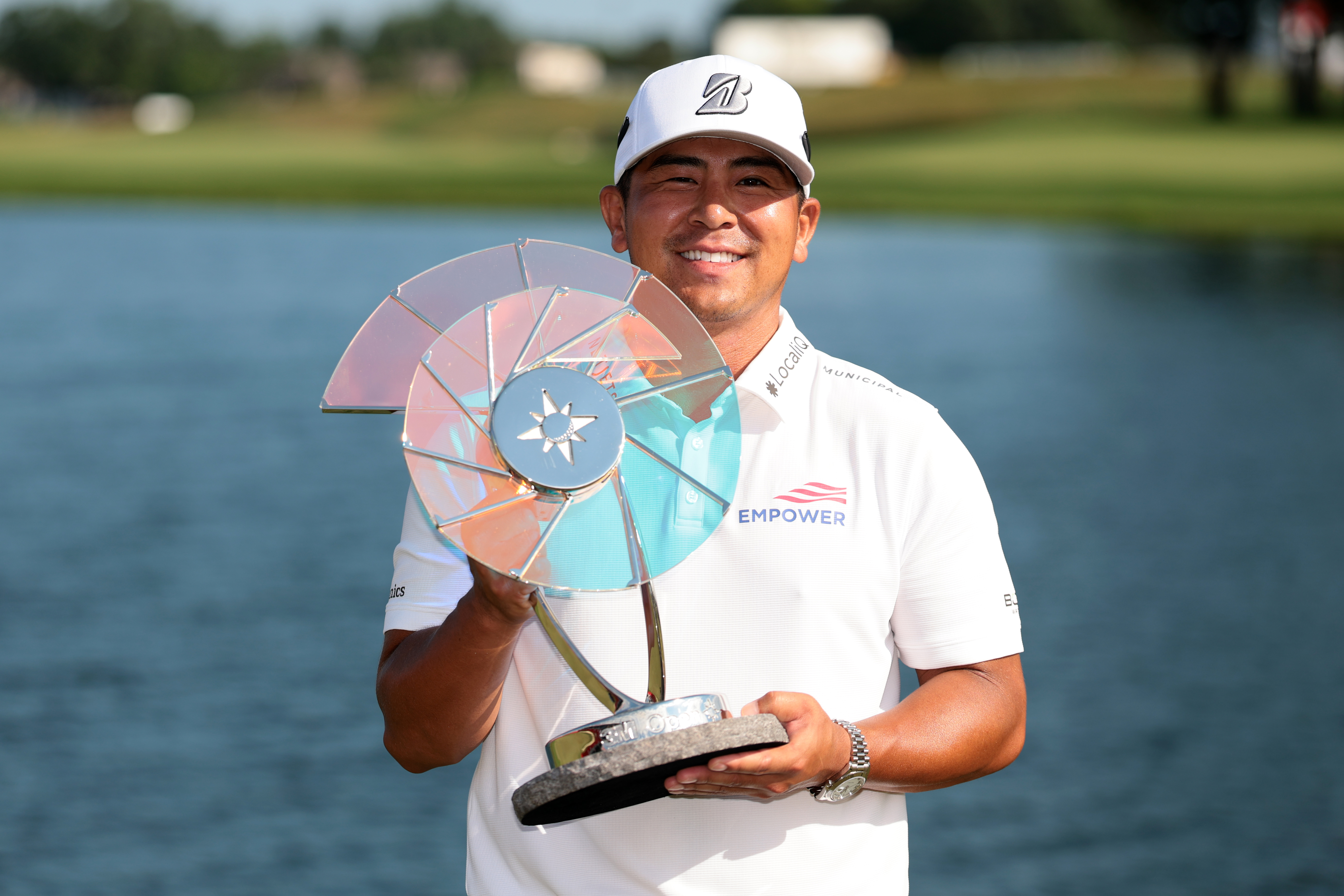 Kurt Kitayama poses with the 3M Open trophy after his win in 2025
