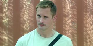 The Kill Team Alexander Skarsgård in a white t-shirt in front of a brown background