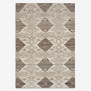 A brown and white patterned vintage rug from Lulu and Georgia