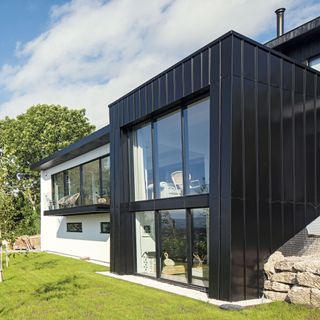 large two storey house with black timber cladding