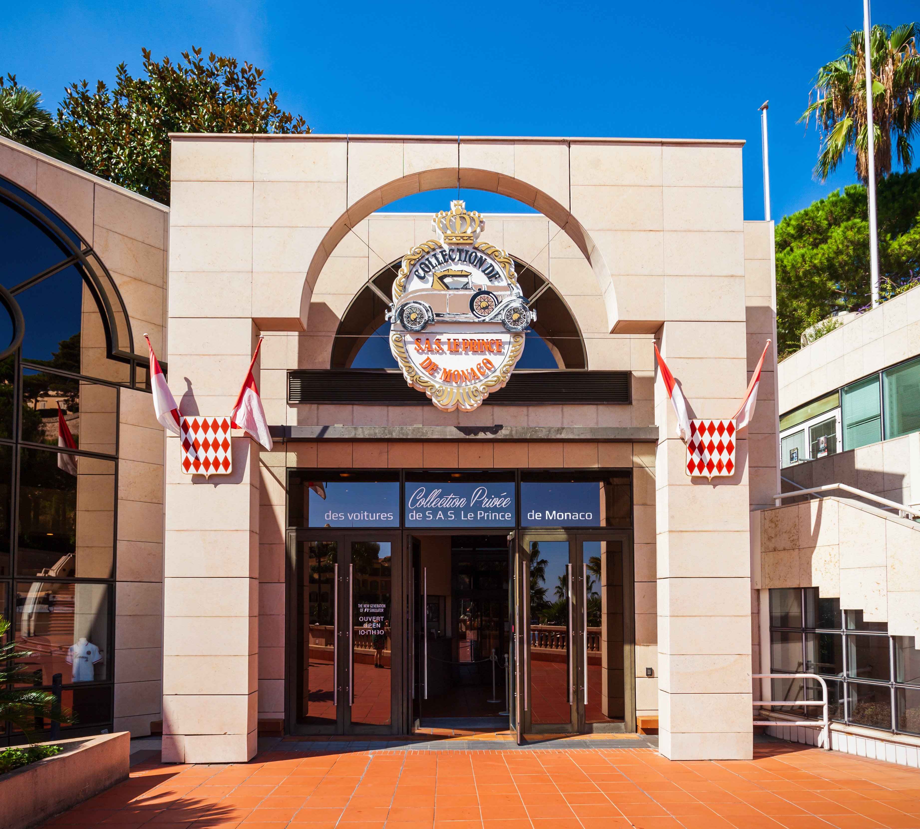 The facade of the car museum, draped in monegasque flags