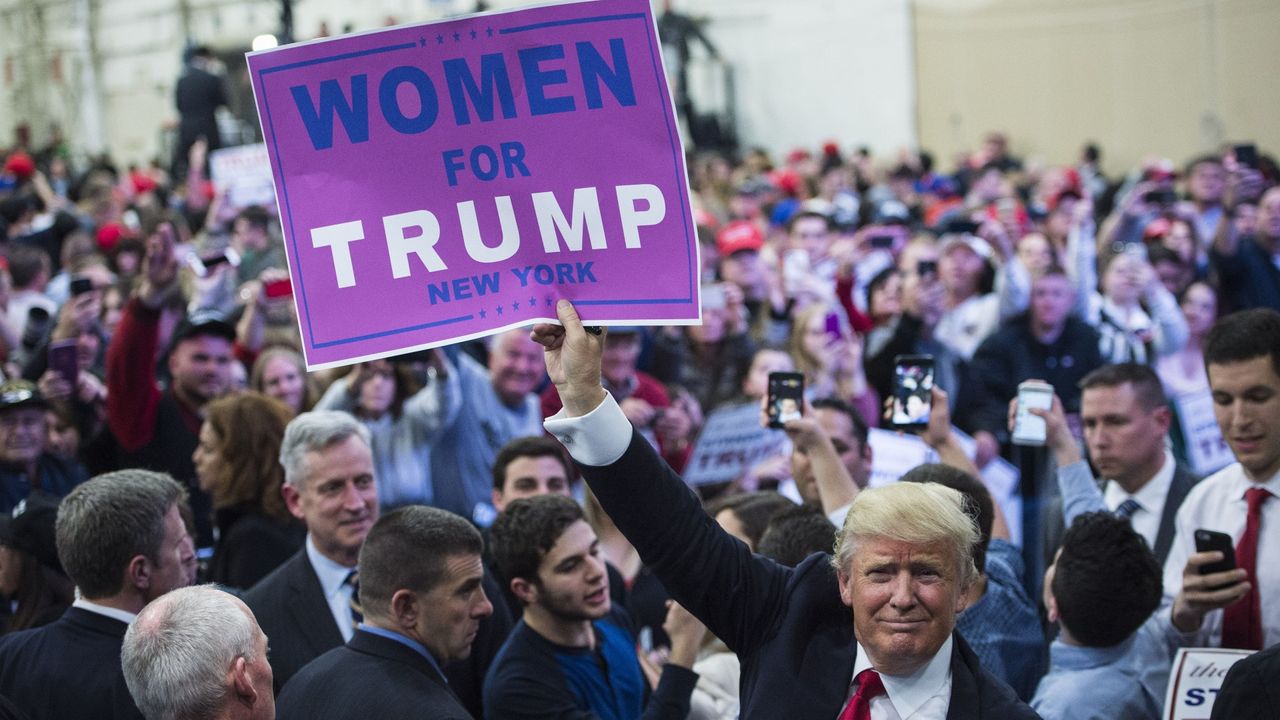 Trump holding poster