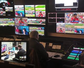 Man working in a control room producing a baseball game