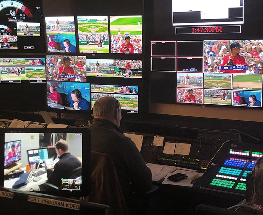 Man working in a control room producing a baseball game