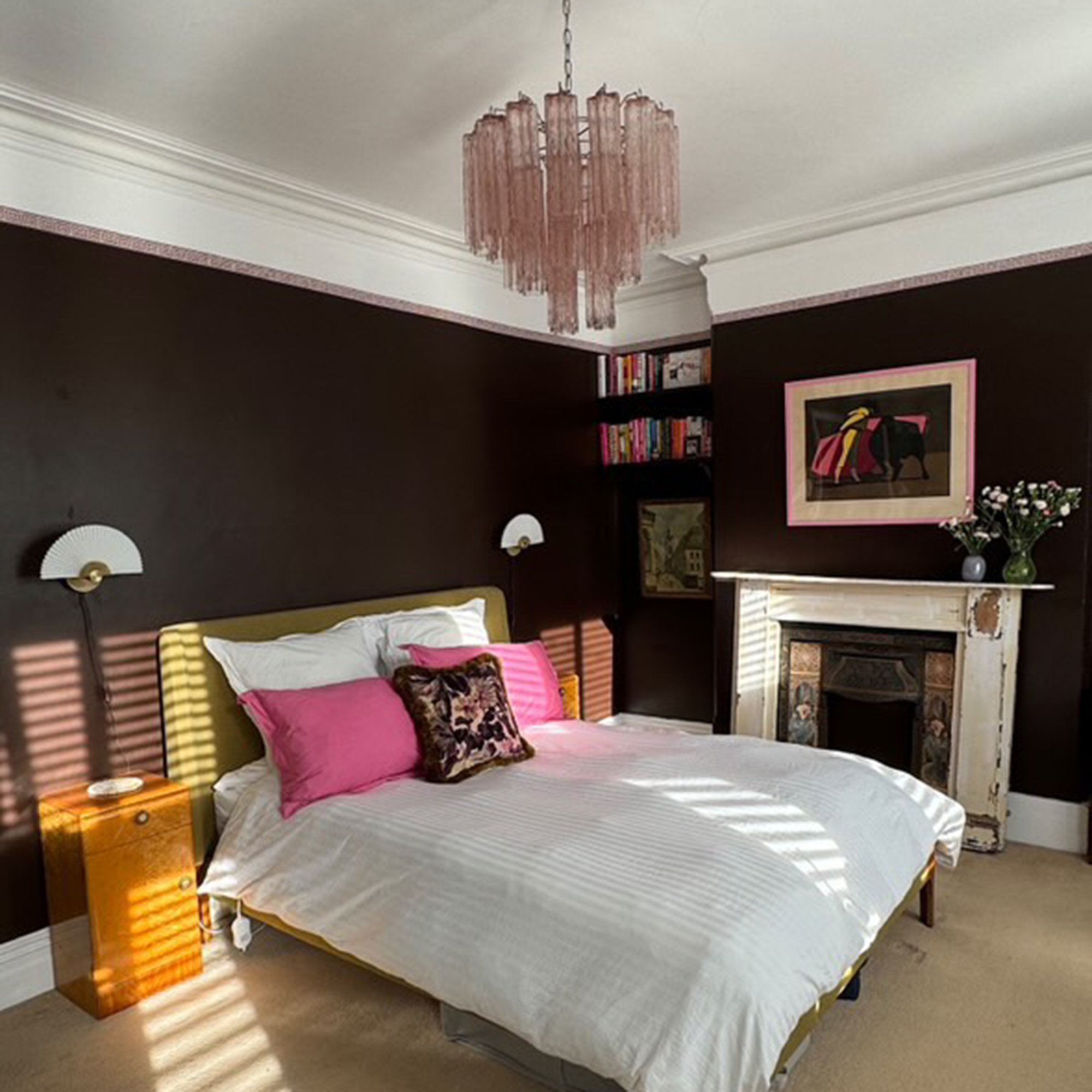 brown bedroom with pink glass ceiling light