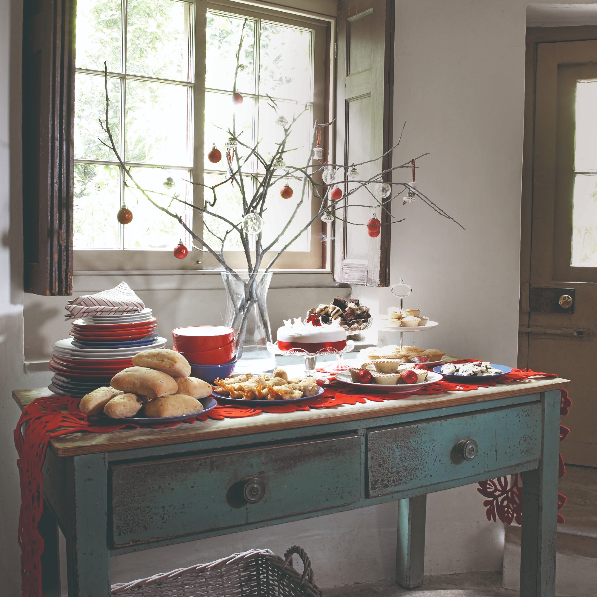 A Christmas buffet set up on a vintage console table