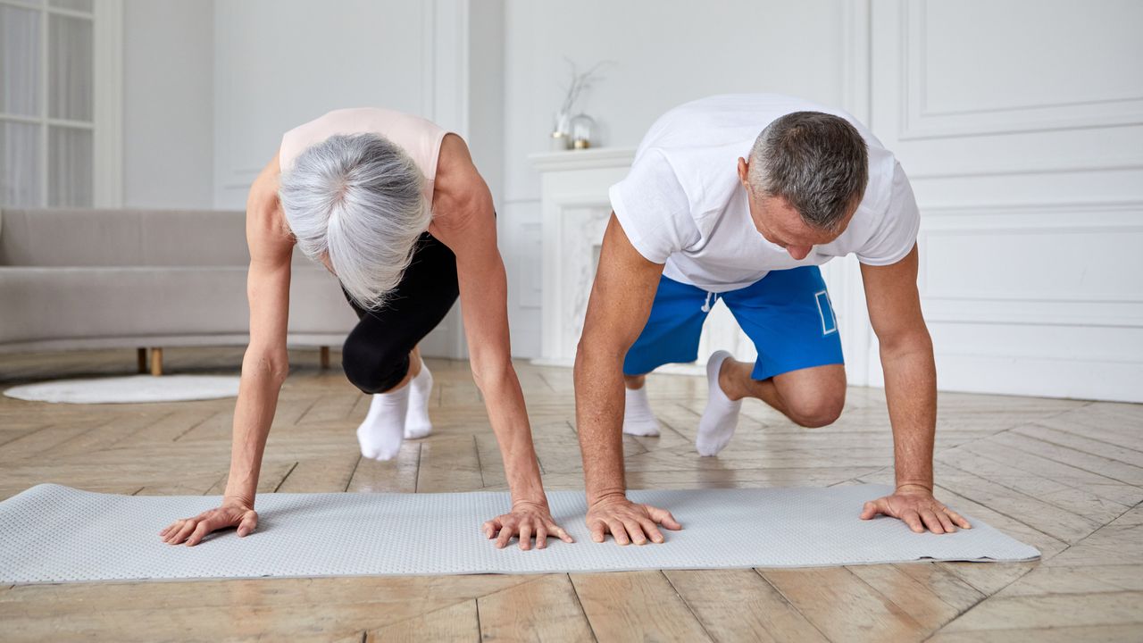 Man and woman exercising in domestic setting