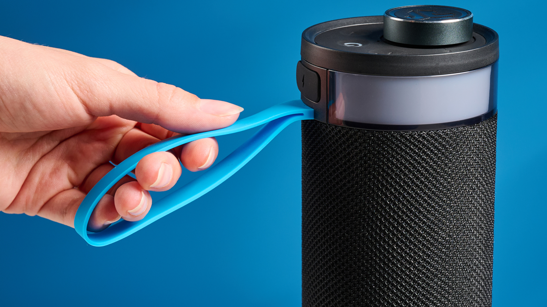 the jlab go party speaker in black with an LED RGB panel and jlab logo photographed in front of a blue background