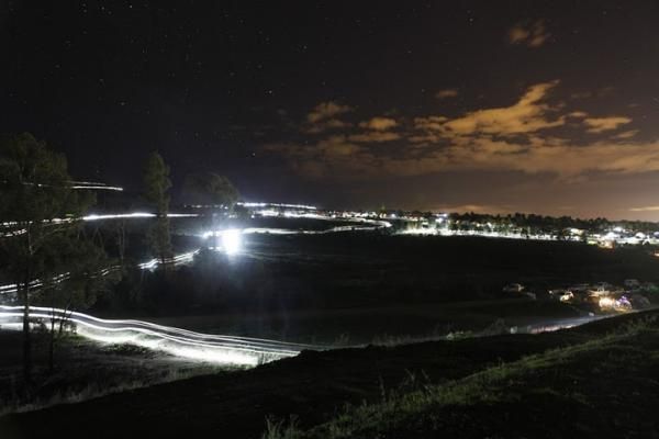 The lights of the riders and their campsites on Mount Stromlo