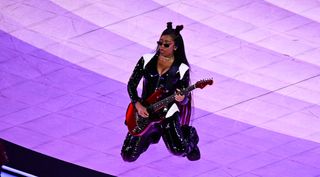 H.E.R. playing the guitar at the Super Bowl