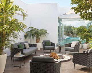 go modern furniture in courtyard with in-ground fire pit