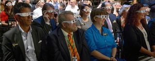 Audience members try on solar filter glasses during a total solar eclipse briefing, Wednesday, June 21, 2017 at the Newseum in Washington.