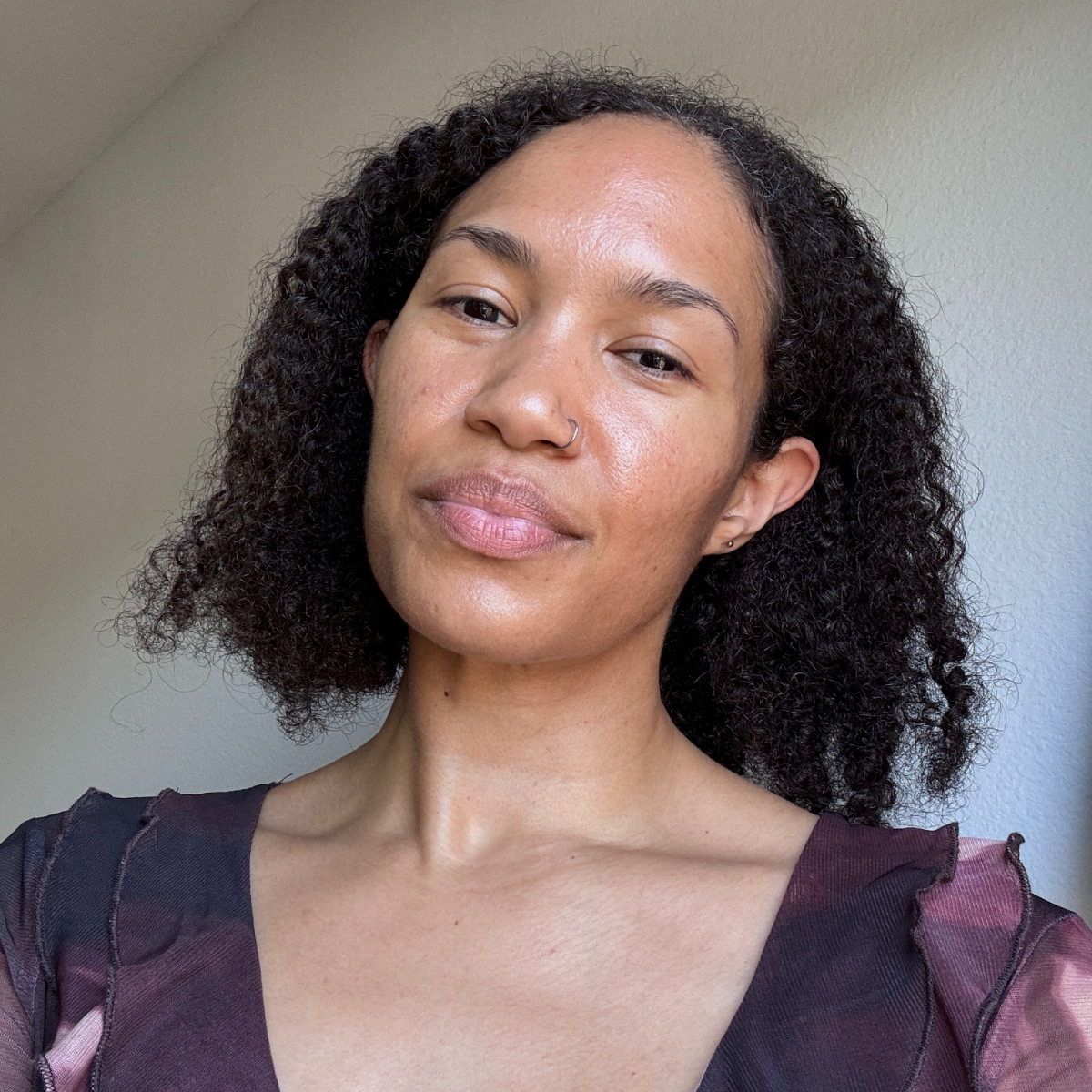 A beauty editor with curly hair before testing the Shark Beauty SilkiPro Straightener