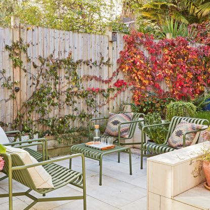 Terrace garden with pale patio tiles and green metal furniture