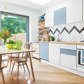 Chevron tiles in blue and white kitchen in extended home