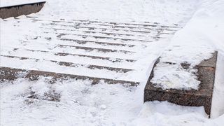 icy cement steps with snow over top