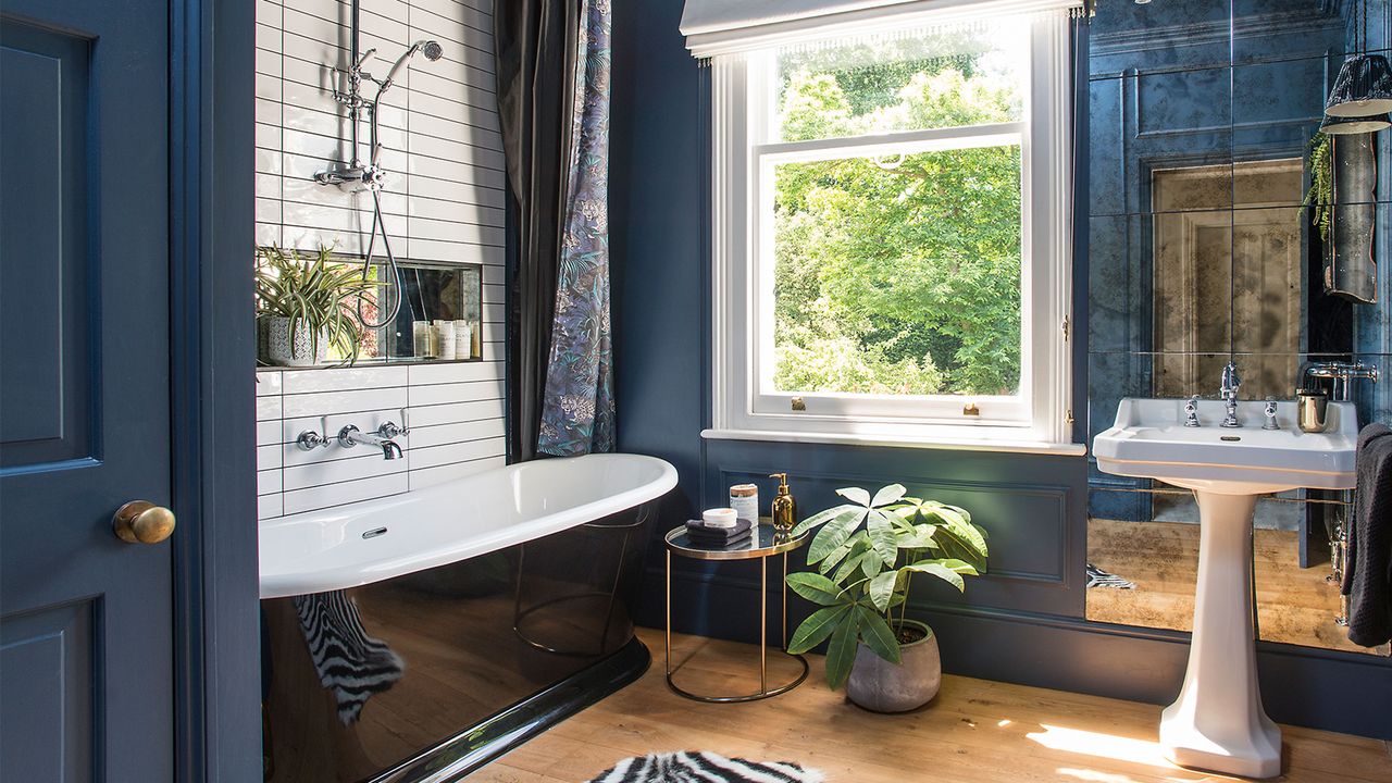 blue panelled bathroom with freestanding bath