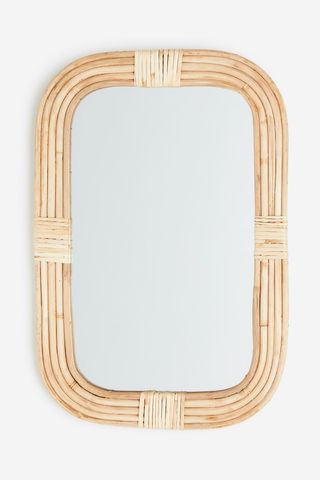 Rattan frame statement mirror in neutral color from H&M Home.