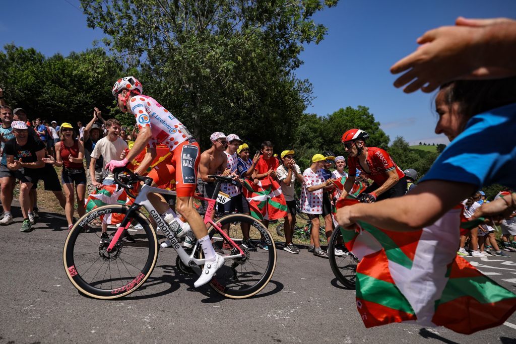 Spectators cheer along the roadside as Team Arkea Samsics French rider Laurent Pichon R and EF Education Easyposts US rider Neilson Powless wearing the best climbers polka dot dotted jersey L cycle in a breakaway in the Basque region of Northern Spain during the 3rd stage of the 110th edition of the Tour de France cycling race 1935 km between AmorebietaEtxano in Northern Spain and Bayonne in southwestern France on July 3 2023 Photo by Thomas SAMSON AFP Photo by THOMAS SAMSONAFP via Getty Images