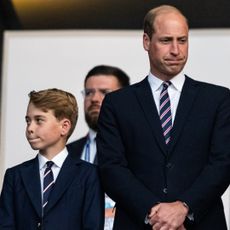 Prince George and Prince William are so alike, both pictured wearing matching suits and pursing their lips in the exact same way