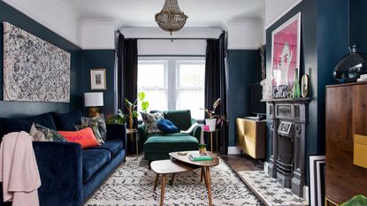 blue living room with blue velvet sofa and fireplace