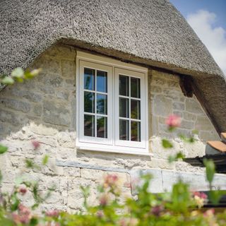 uPVC windows in thatched stone building