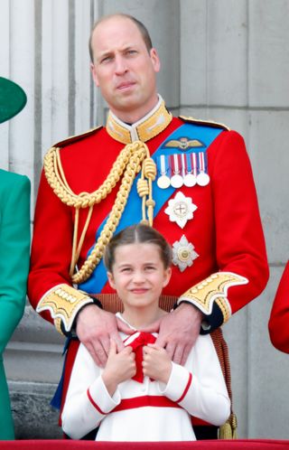 Prince William holds onto Princess Charlotte's shoulders at Trooping the Colour