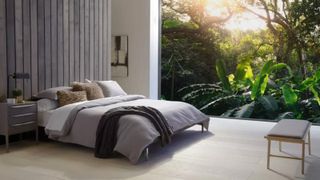 An organic mattress, the Saatva Zenhaven mattress in bedroom with big window looking outside