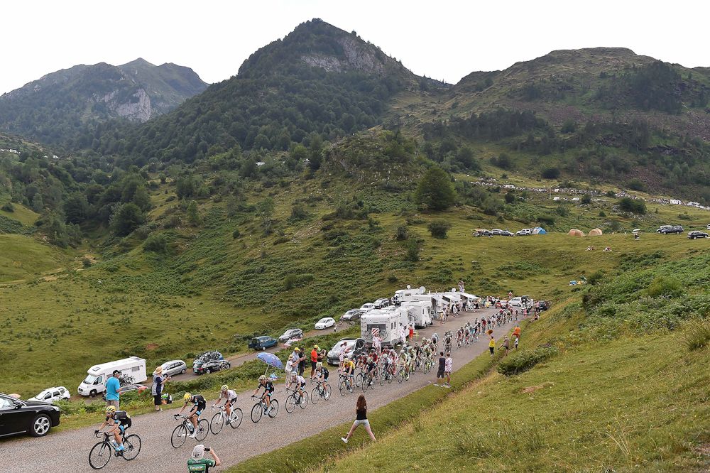 The peloton rides through the mountains during stage 12.