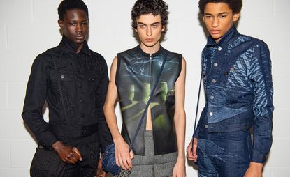 3 male models in denim & leather looking down